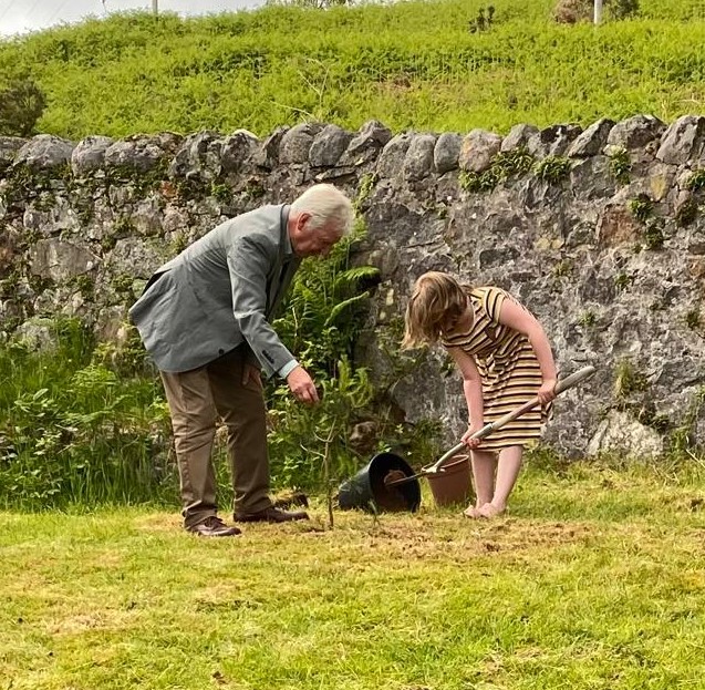 Phoebe Lavis-Jones and Andrew Campbell planting the Scots Pine